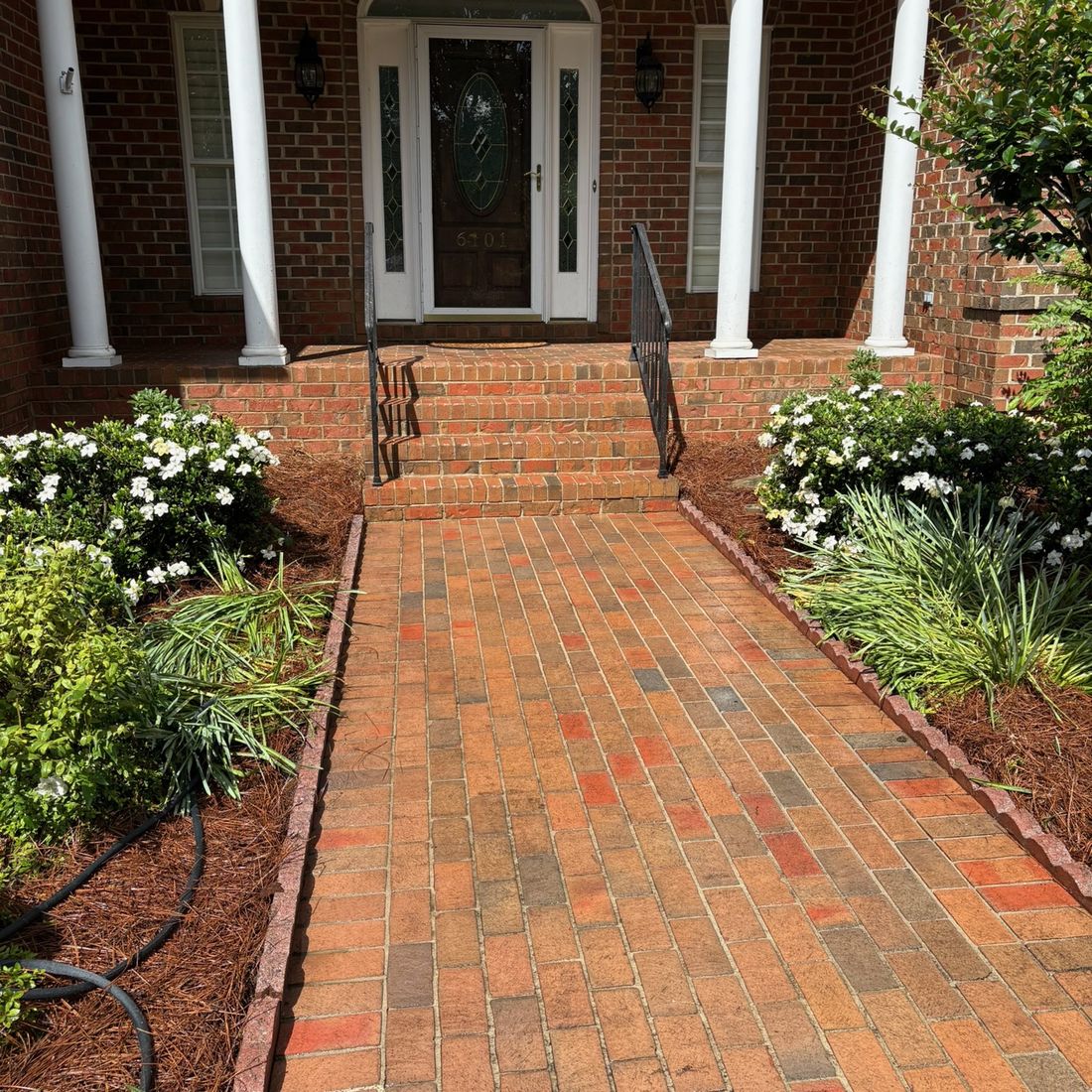 Brick walkway after pressure washing, brick colour fully restored